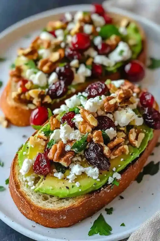 Savory avocado toast with feta, nuts, and cranberries on crisp sourdough