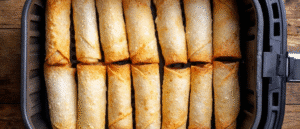 Frozen taquitos and flautas arranged in air fryer basket